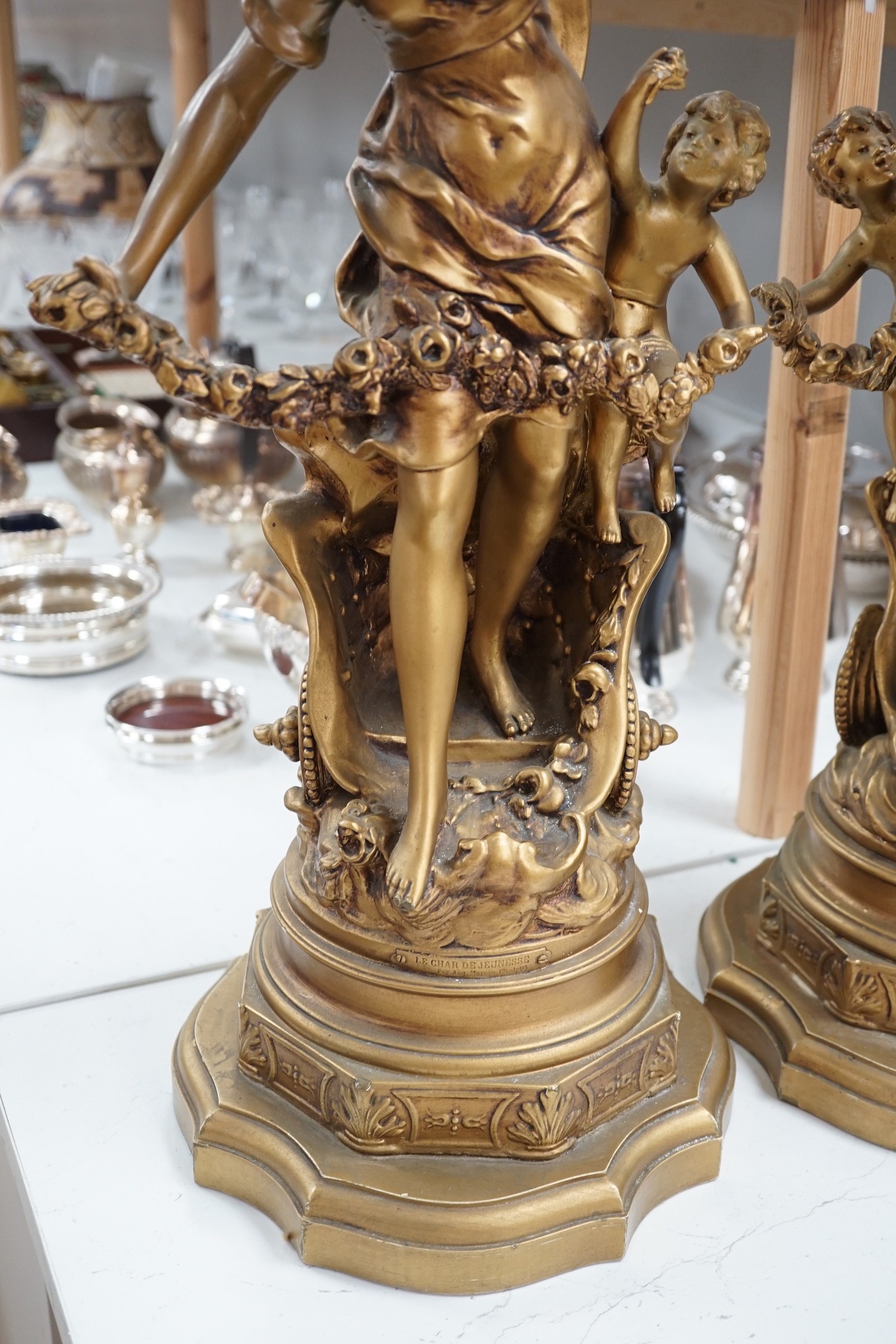 A pair of gilt spelter groups of a classical maiden and cherub, 61cm tall